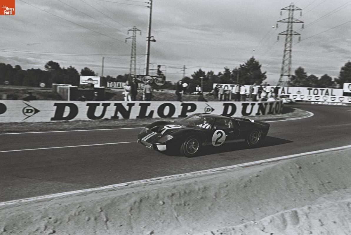 Bruce McLaren's and Chris Amon's Ford GT40 Mark II at the 24 Hours of Le Mans Race, June 1966 Race car on race track with a few spectators looking on from the sidelines