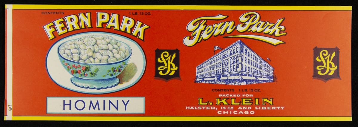 Red label with text and images of hominy in a blue painted bowl and a building
