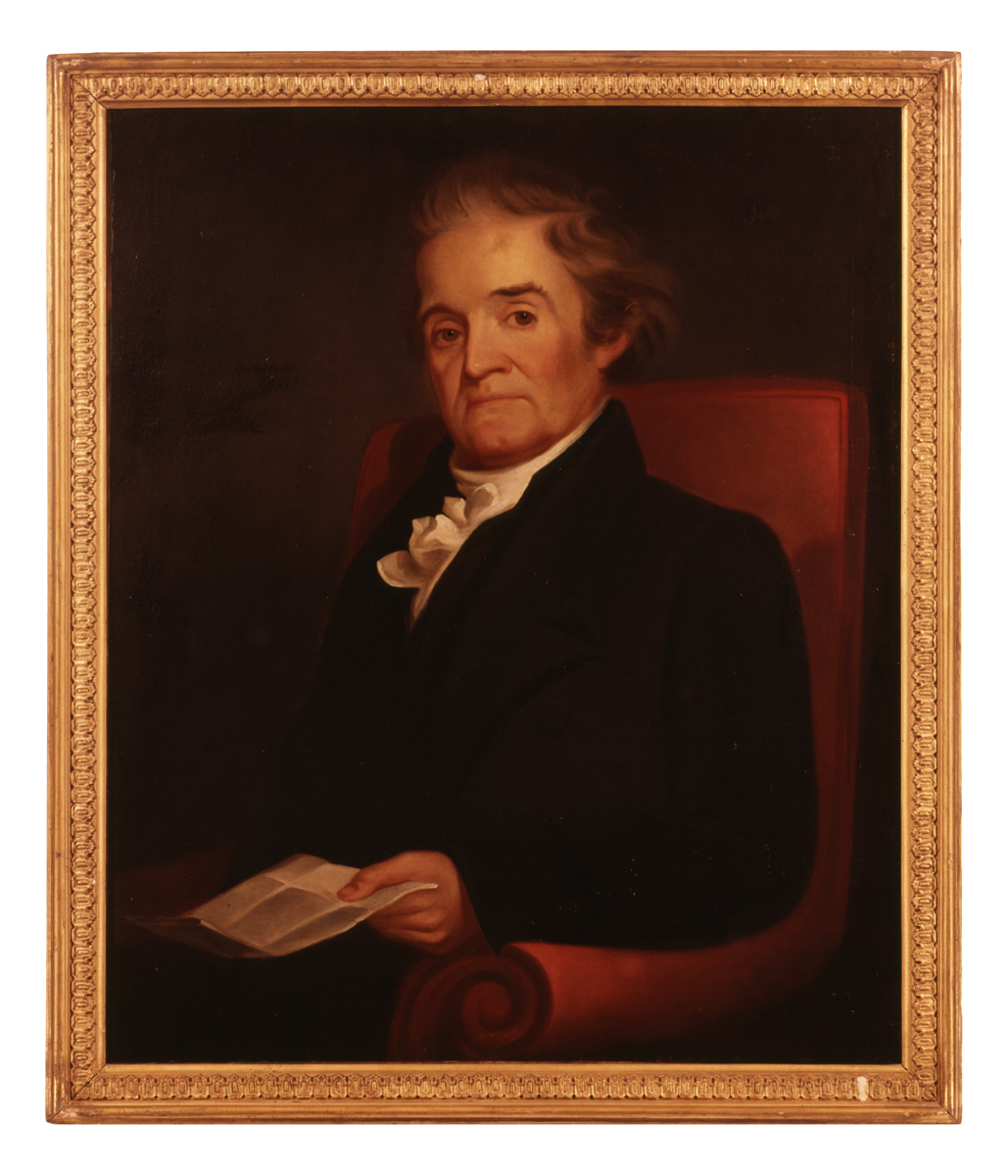 Painting of man with white hair in dark suit and white cravat, sitting in an armchair and holding a piece of paper
