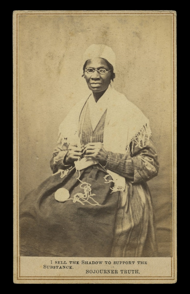 Portrait of Sojourner Truth, "I Sell the Shadow to Support the Substance," circa 1864 Black-and-white image of dark-skinned woman in shawl and cap knitting and looking at camera; also contains text