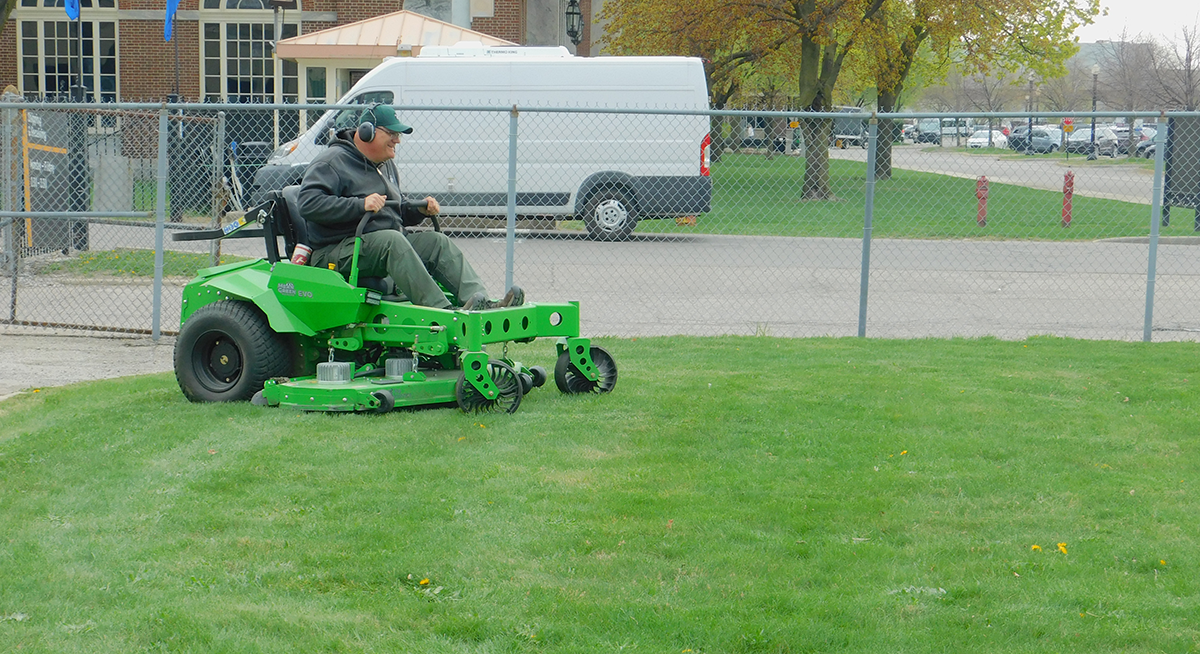 EvoMower Staff member riding the Evo electric zero-turning riding mower.