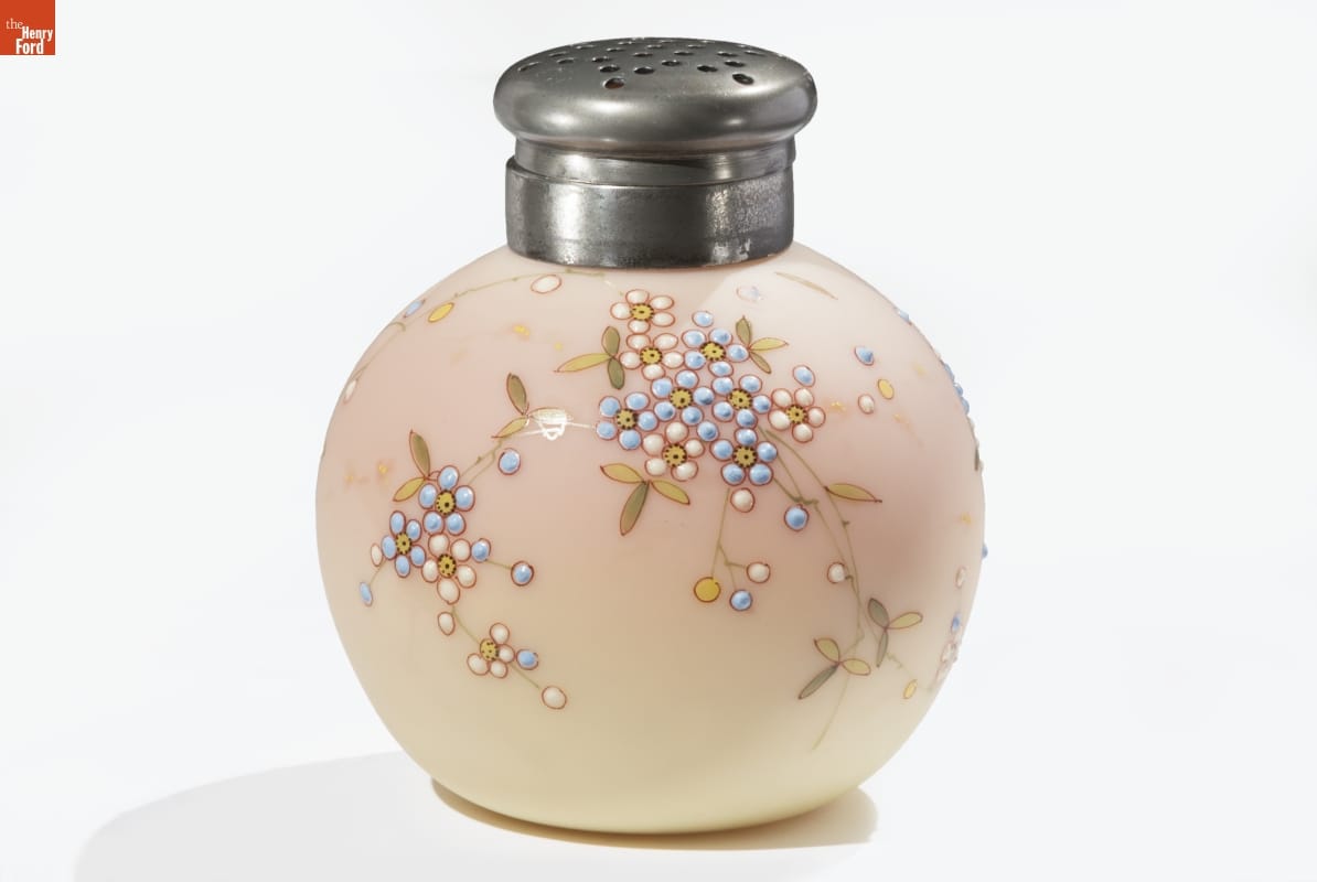 Burmese Caster, 1885-1895 Round glass container with "salt shaker" type top and raised pattern of flowers, in shades of cream and peach