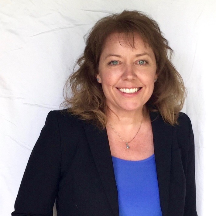 Michele Spirko, Amherst, Massachusetts Medium-light-skinned woman with brown hair in blue shirt and black blazer