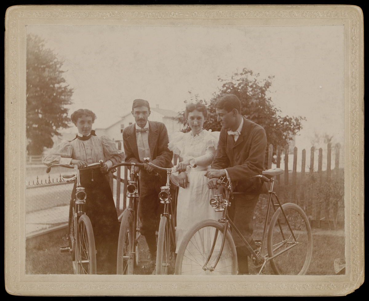 Young Men and Women with Their Bicycles, Waterville, Ohio, circa 1895 Two women in dresses and two men in suits, each standing next to a bicycle