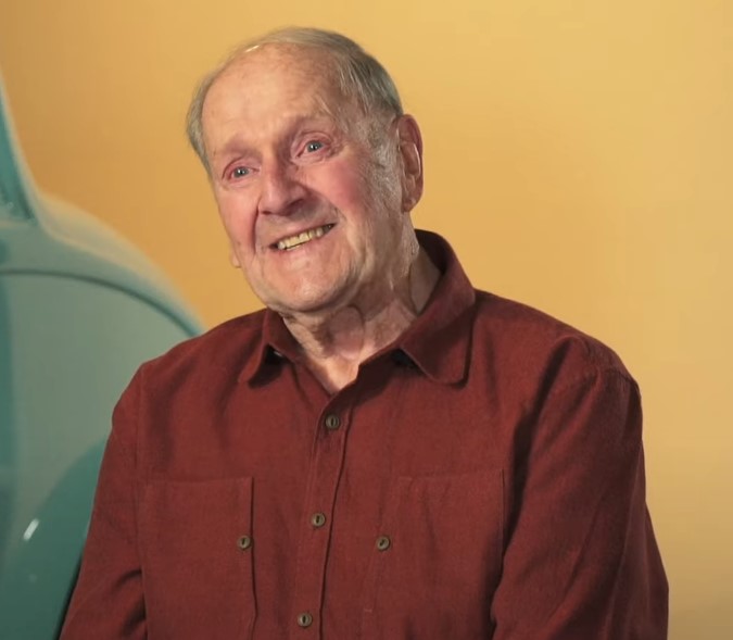 Mose Nowland Portrait of seated man in maroon-colored shirt