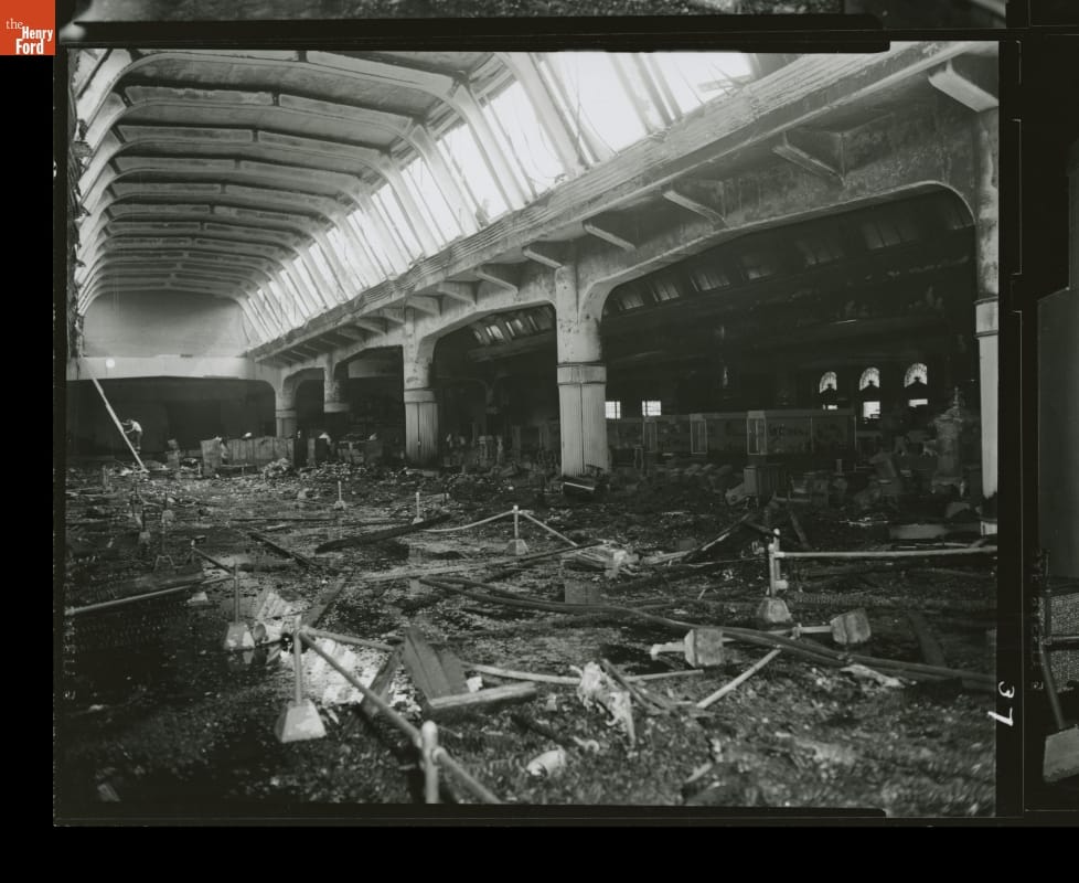Large space with arched celling, full of debris and water