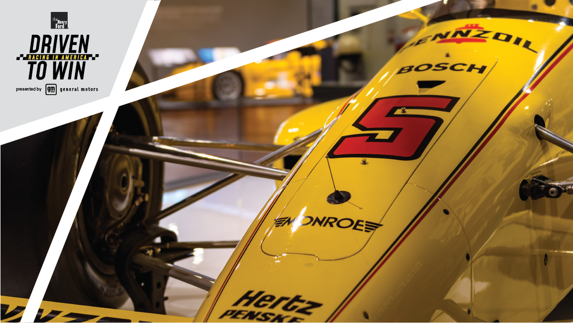 Tight shot of hood and wheel of low yellow race car with number 5 and other text on hood