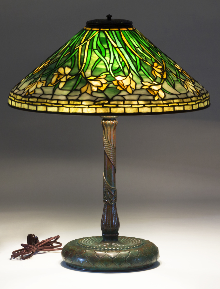 Electric Table Lamp, 1903-1920 Lamp with bronze base and stem and stained glass shade featuring daffodils