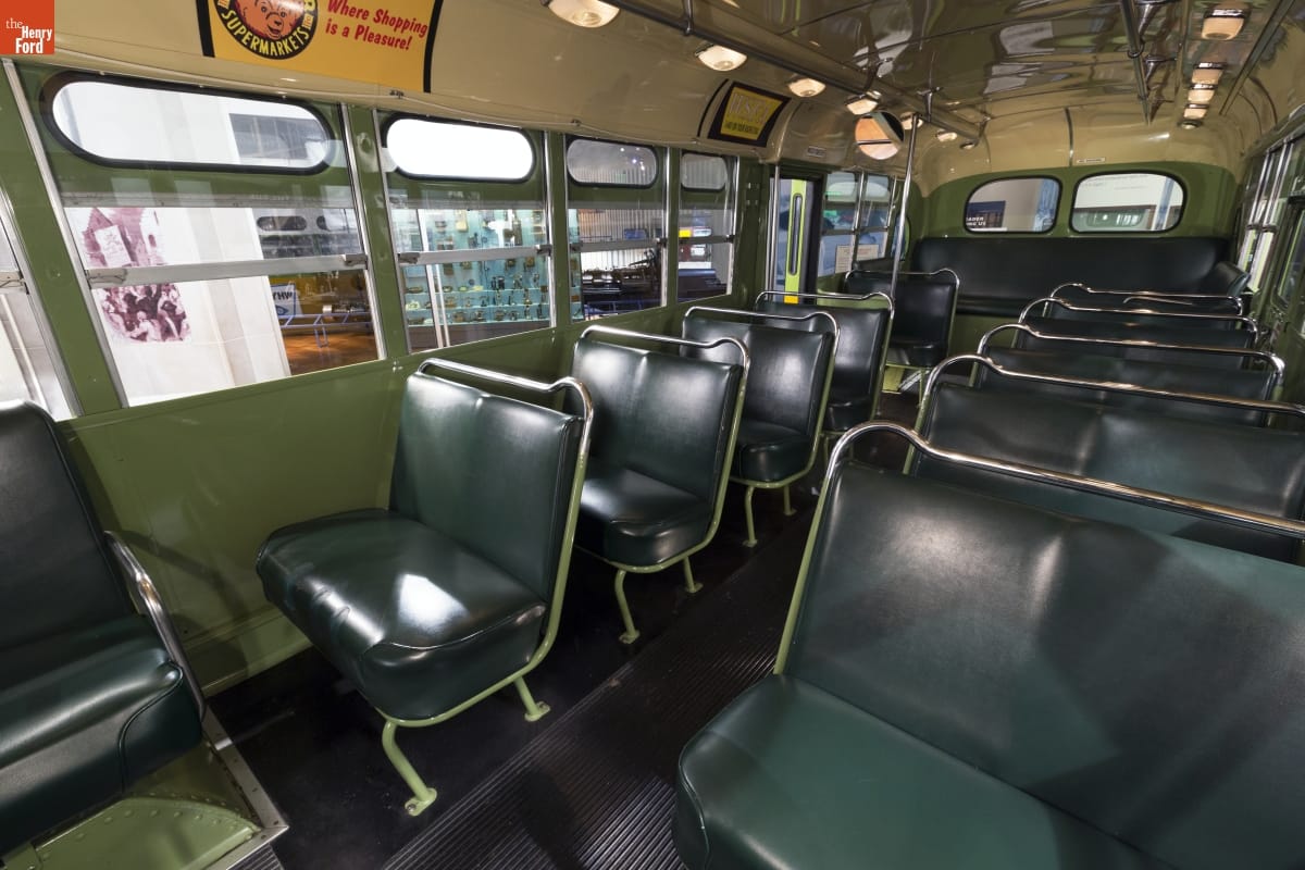 Inside the Rosa Parks Bus Interior of a bus with green bench seats
