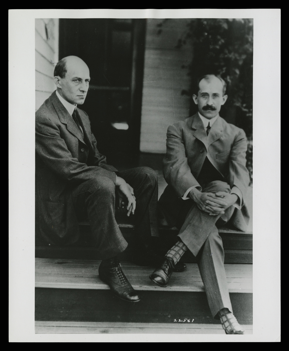 Wilbur and Orville Wright at Home in Dayton, Ohio, circa 1910 Two men in suits sit on porch steps