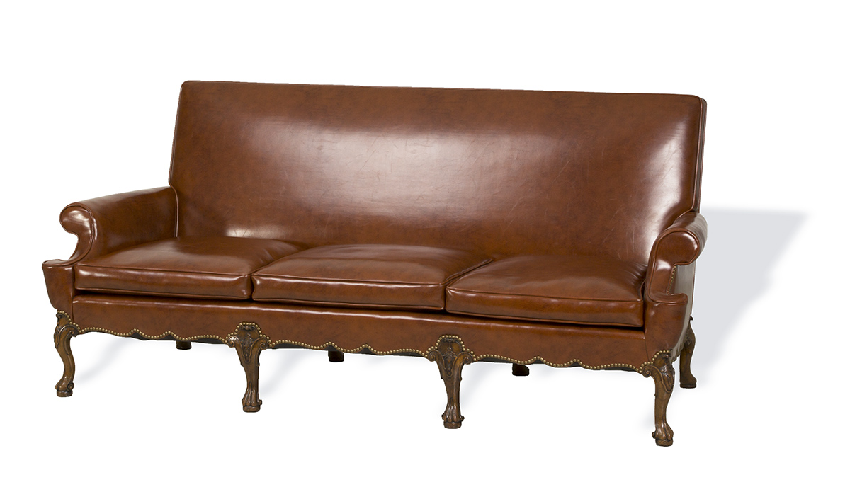 Sofa, Made 1923, Used by Henry Ford at the Ford Motor Company Engineering Laboratory Brown leather sofa with decorative wooden legs