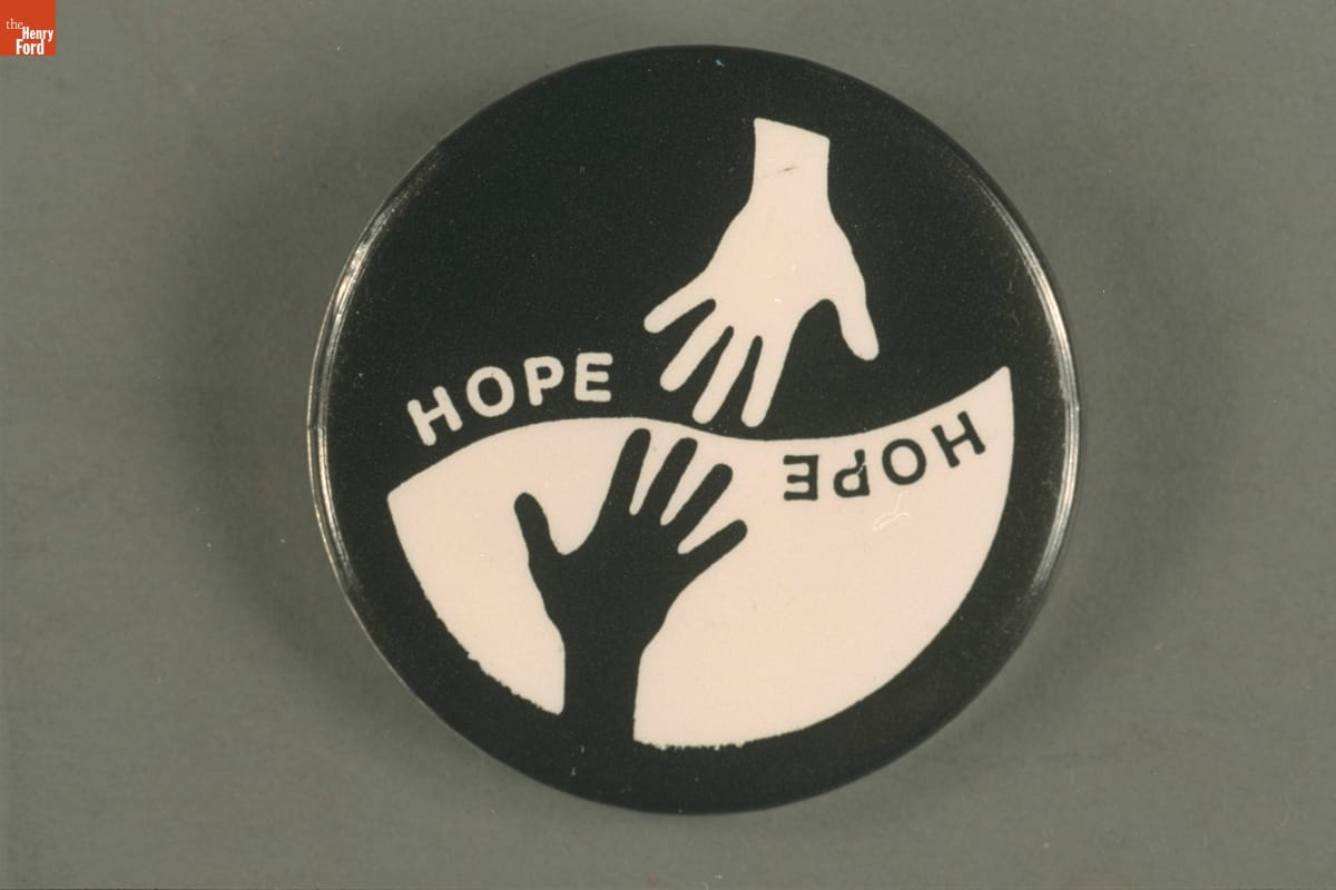 Focus: HOPE Button, 1999 Round button with top portion displaying a white hand and word "hope" on a black background, and the bottom half with the same elements but black and white reversed