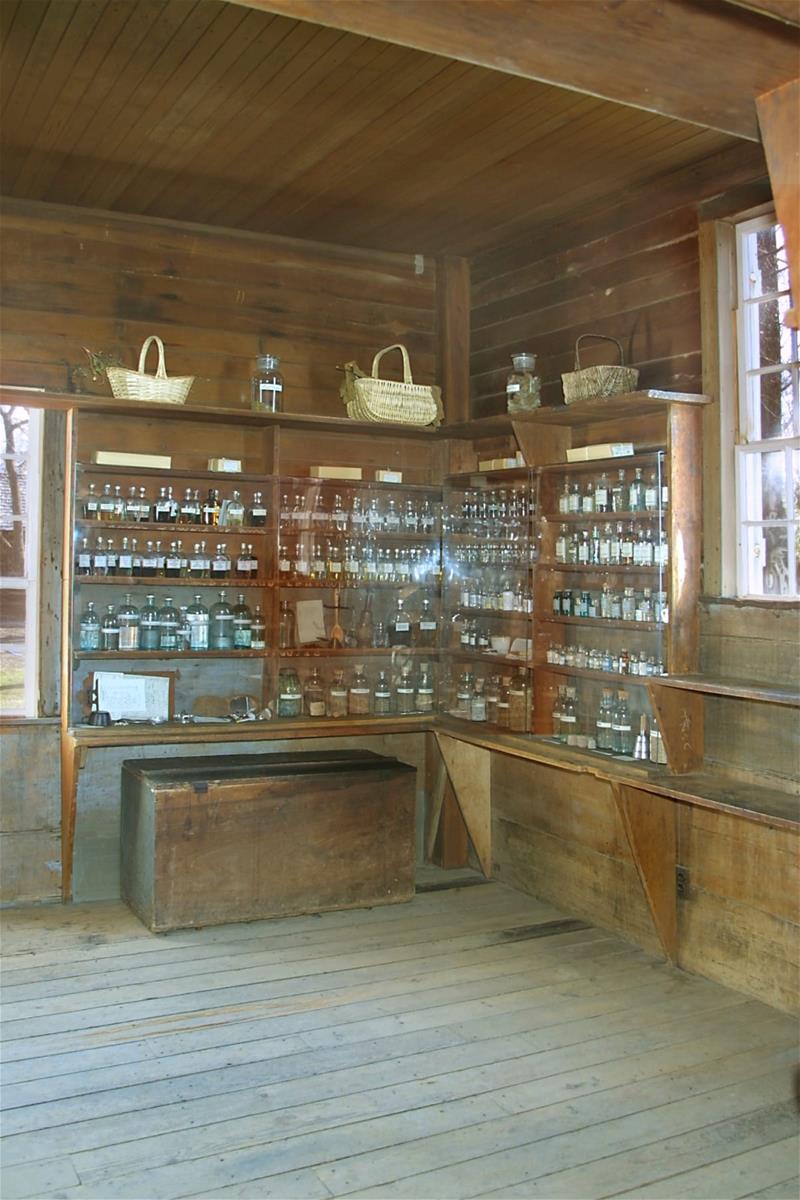 Dr. Howard's Office / interior Corner of room with shallow wood shelves filled with baskets, bottles, and jars