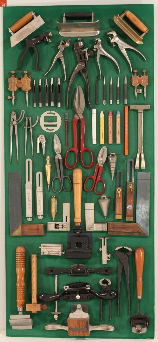L. Miller & Son Store Display of Snips, Planes, Plumb Bobs and Measuring Tools, 1923-1928 Display case containing a variety of tools hung against a green background