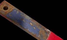 Wooden board with gray-blue and red paint on it