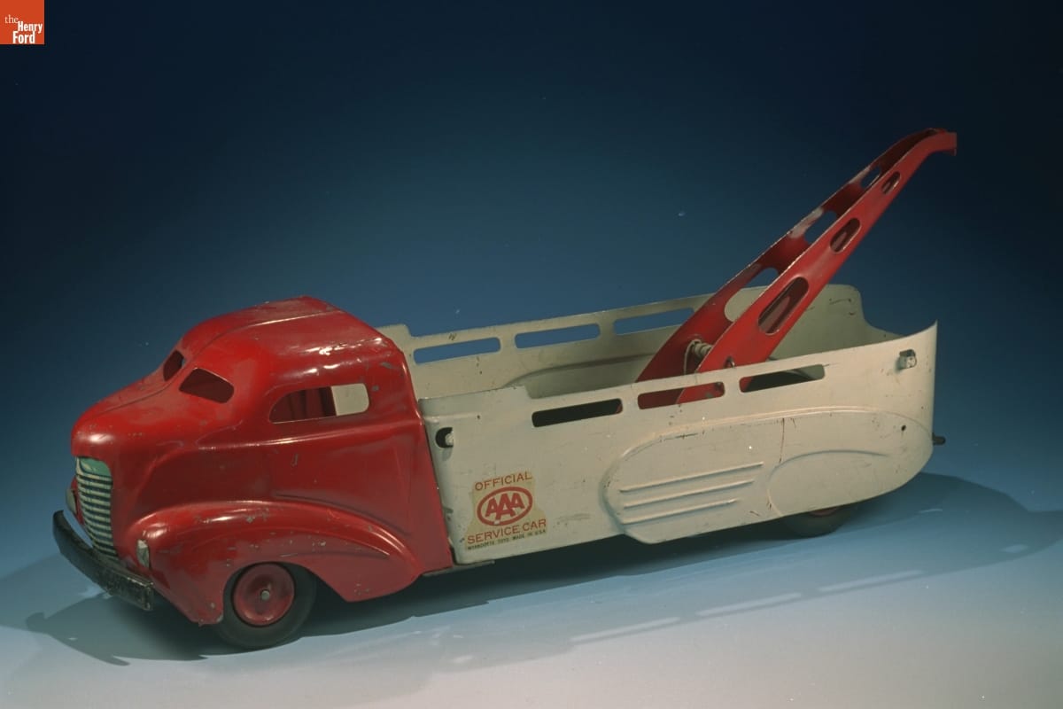 Toy Tow Truck, 1937-1946 Toy truck with red cabin, white bed, and red winch in bed, with AAA logo on side
