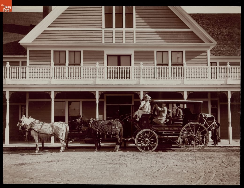 Yellowstone Park Stage Leaving Fountain Hotel, Yellowstone National Park, Wyoming, circa 1910 Black-and-white photo of a horse-drawn stagecoach filled with passengers in front of a building