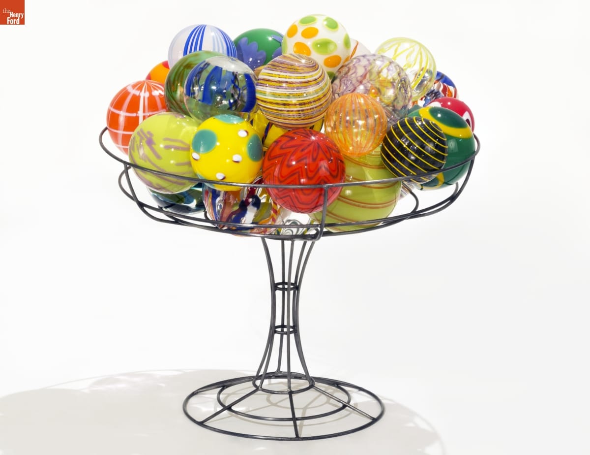 "Patterns of Thought: Eye Candy" by Ginny Ruffner and Steve Kursh, 1994 Colorful glass balls are stacked in wire "holder" for display