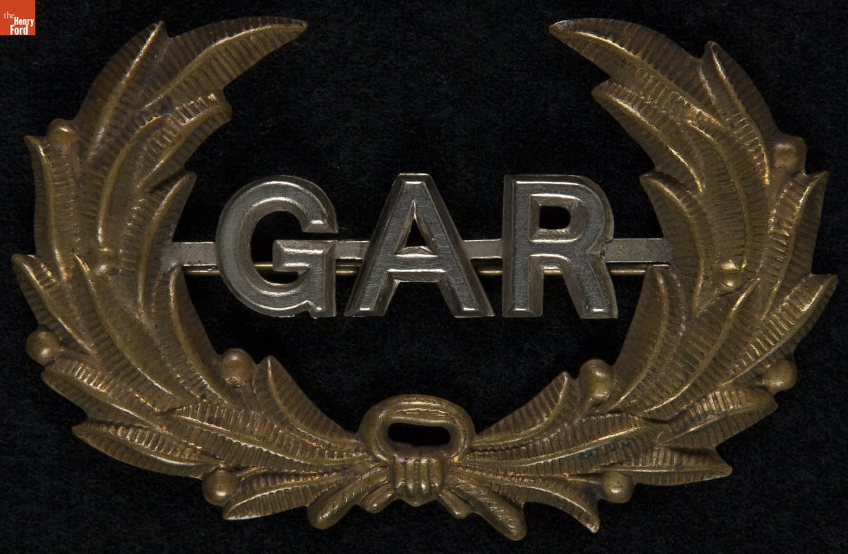 Grand Army of the Republic (G.A.R.) Hat Insignia, 1867-1920 Metal pin with gold laurel and silver letters "GAR"