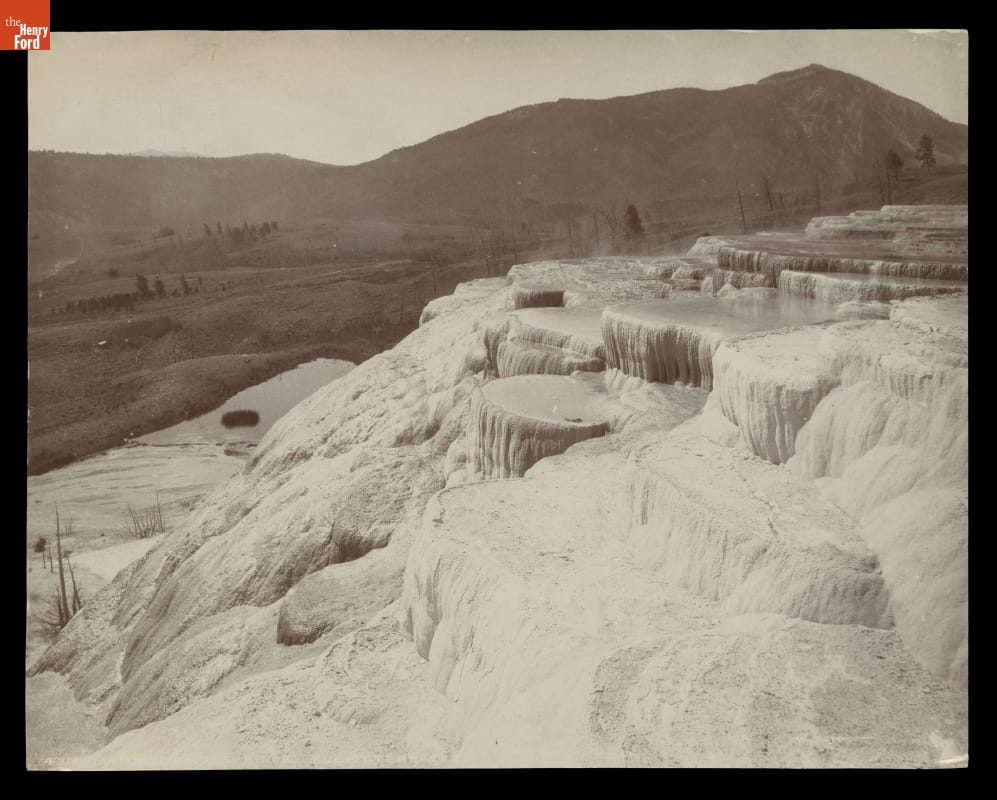 Mammoth Hot Springs, Pulpit Terraces, Yellowstone National Park, circa 1892 Black-and-white image of slope covered in water and/or calcified rock with hills or mountains in the background