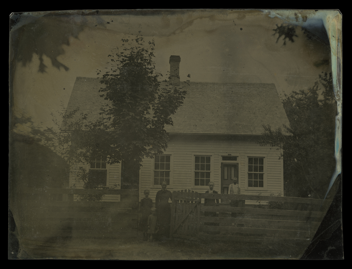 Webster Family outside Their Farmhouse, Concord, Delaware County, Ohio, circa 1881 People standing behind fence and at gate in front of wooden house