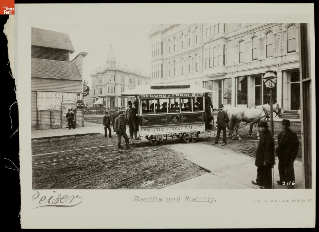Horse-Drawn Streetcar, "Seattle and Vicinity," Seattle, Washington, circa 1890 Street scene with a horse-drawn streetcar in middle of road and buildings and pedestrians along the streets