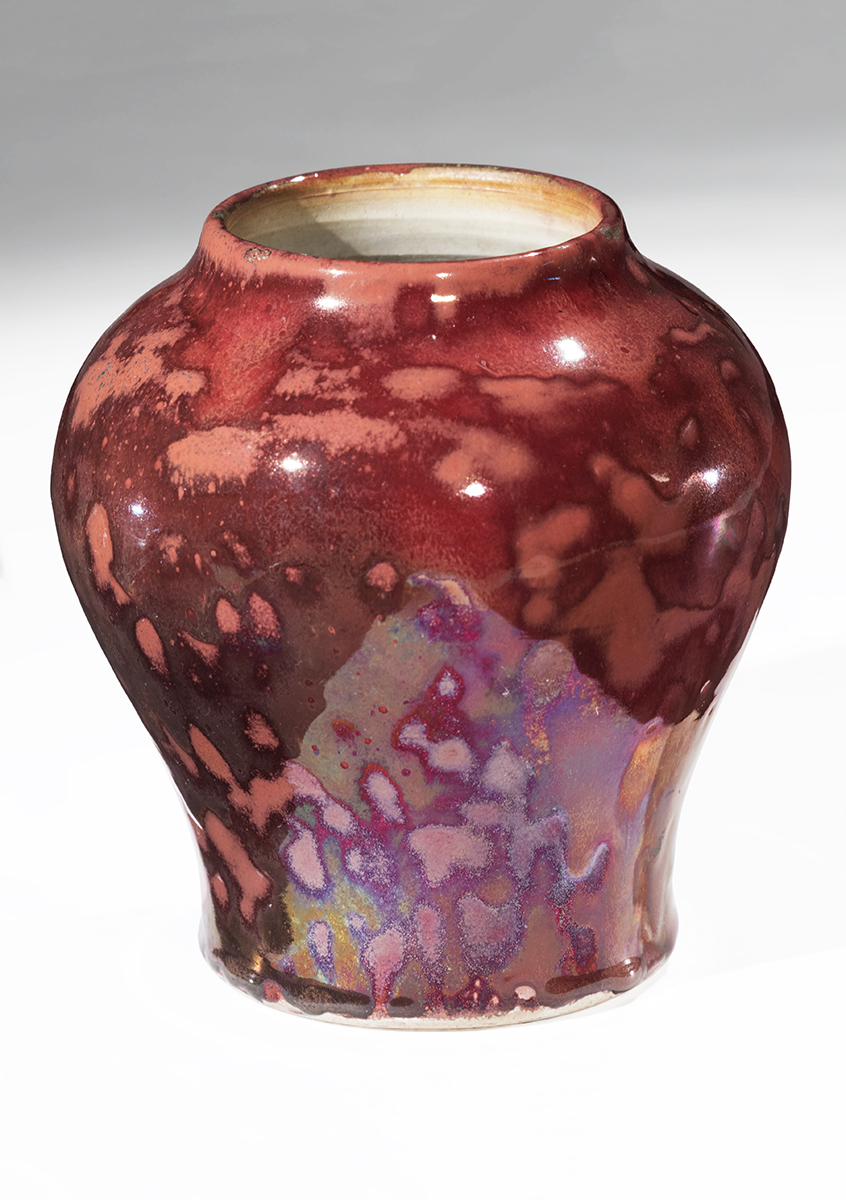 Vase, 1896-1908 Small vase with narrow base rounding out, then narrowing again at mouth, with mottled reddish colors ranging from peach to dark maroon