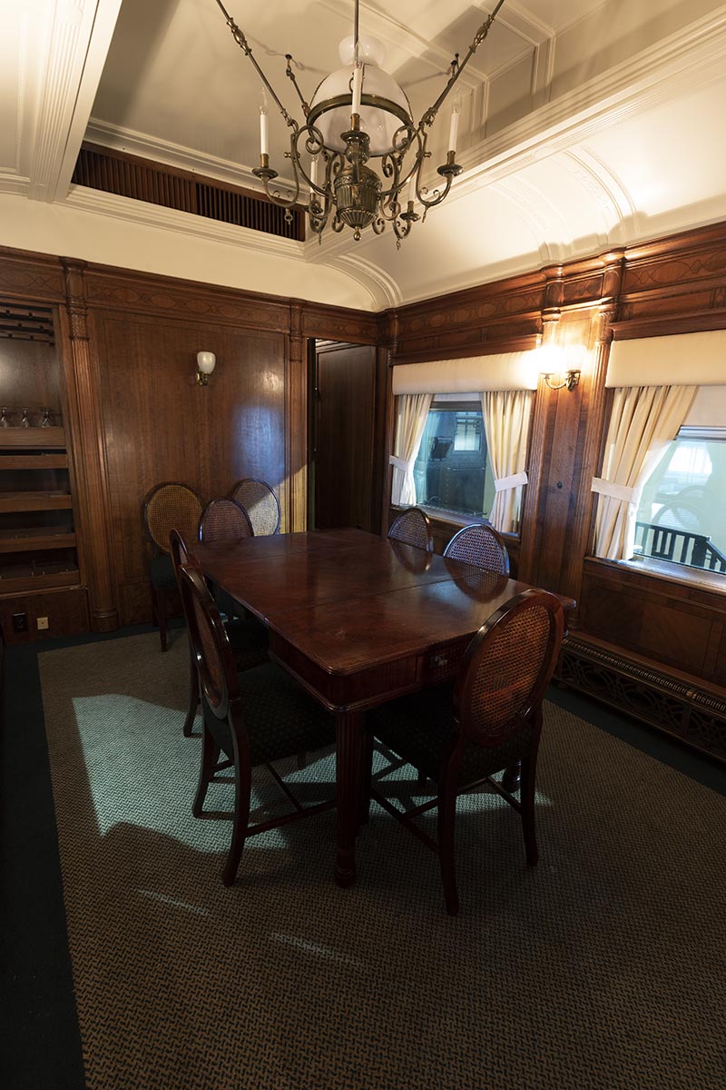 Henry Ford's Private Railroad Car "Fair Lane," 1921 / dining saloon Interior of room with wood paneling, arched ceiling, dining table, and chairs