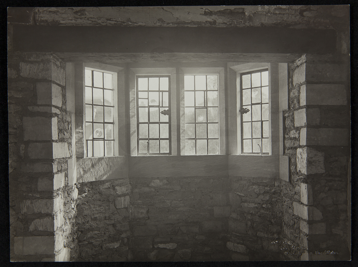 Interior of Cotswold Cottage at its Original Site in Chedworth, Gloucestershire, England, 1929-1930 Interior view of bay window with four paned windows set in stone wall