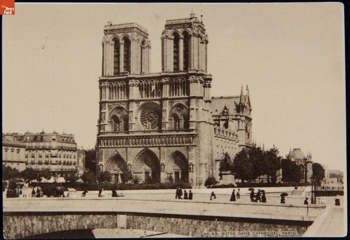 Trade Card for C.I. Hood & Co. with Hood's Photos of the World, "Notre Dame Cathedral, Paris," 1890-1910 Black-and-white photo of gothic cathedral; people passing on roadway in front and other buildings visible to the side