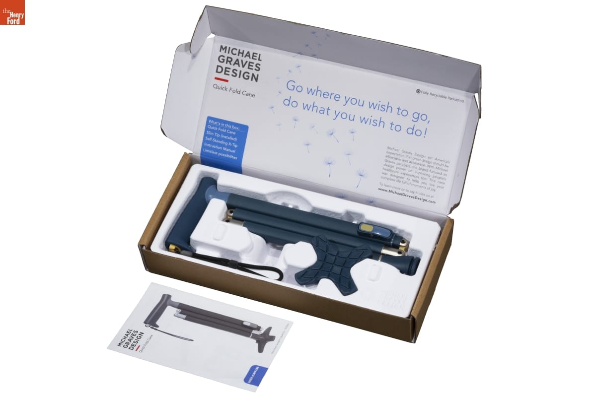 Quick Fold Cane, 2021 Box with black plastic item in foamcore inside and text inside top flap; instruction pamphlet sitting in front of box