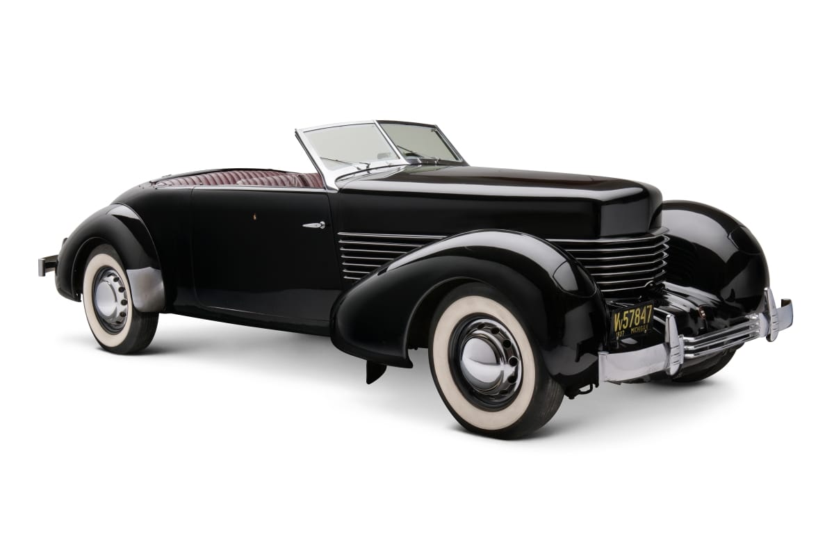 1937 Cord 812 Convertible Long black convertible with swooping lines and whitewall tires