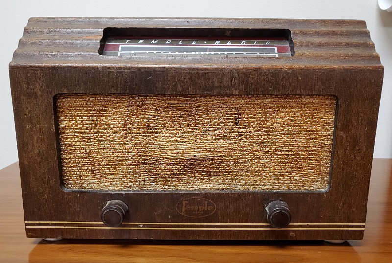 Radio designed by Peggy Ann Mack Rectangular brown radio with two knobs and tan-colored fabric on front