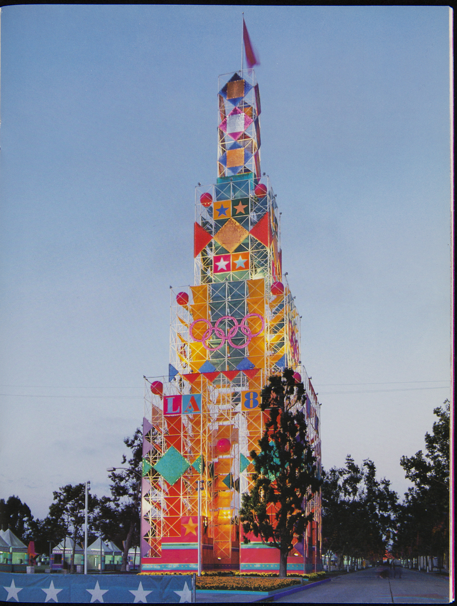Design Quarterly 127, LA 84 Games of the XXIII Olympiad, 1985 Large colorful tower with decorative scaffolding and images of stars, geometric shapes, and Olympic rings