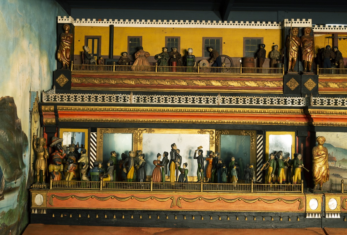 "The Busy World" Automaton, 1830-1850 / detail Wooden platform with two carved scenes with human figures, one above the other