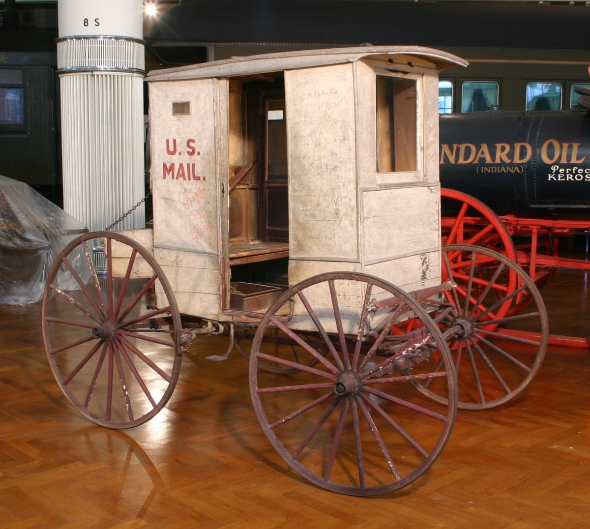 Mail Wagon Used for Rural Delivery in Missouri, 1902-1925 Small, boxy carriage with open doorway and text "U.S. MAIL" on side