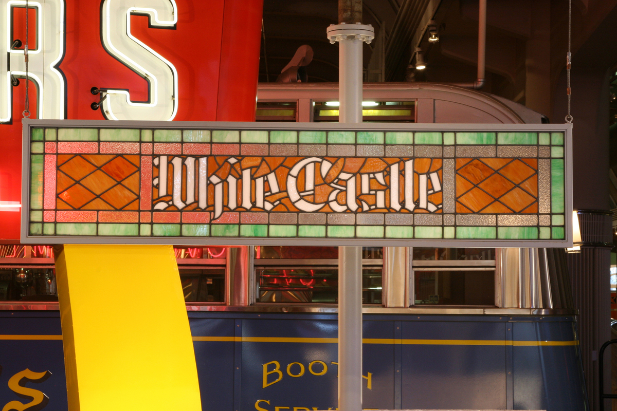 Stained Glass White Castle Sign, 1930s Stained glass sign in red, orange, and green, with white text "White Castle," with other items visible in background