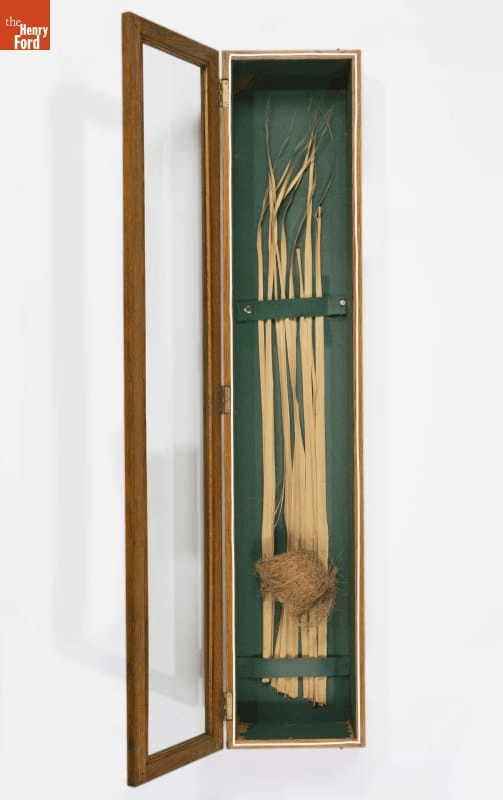Three artifacts related to weaving GIF cycling through three images: oriole's nest attached to reeds in display case; large, drill-shaped machine in room; and outline of bear created with yarn or string
