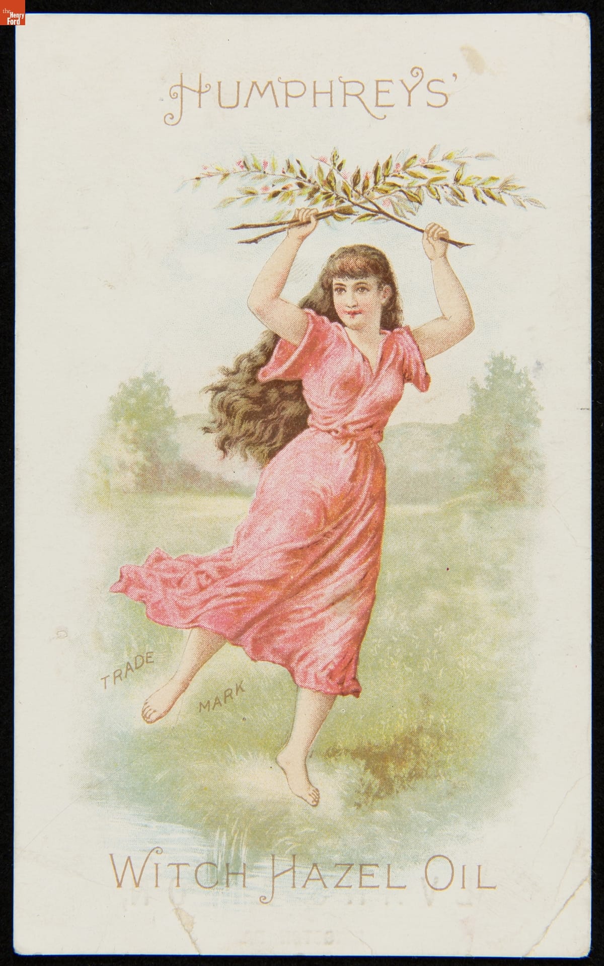 Trade Card for Humphrey's Witch Hazel Oil, Humphrey's Med. Co., 1870-1900 Illustration of woman in red dress in field, one leg held out behind her, holding two leafy branches crossed above her head; also contains text