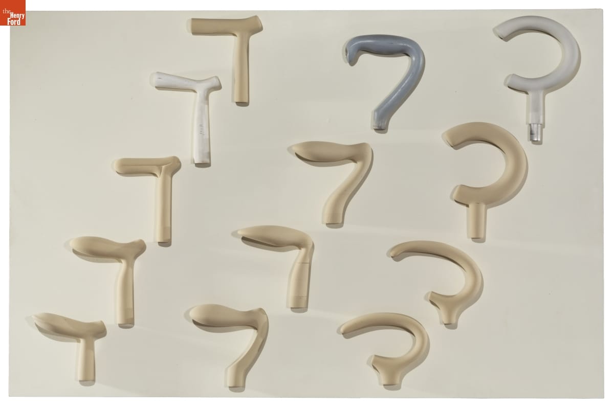 Cane Handle Models on Display Board, 2014-2015 Board with different styles and shapes of cane handles mounted on it--mostly gold but also silver and gray colored