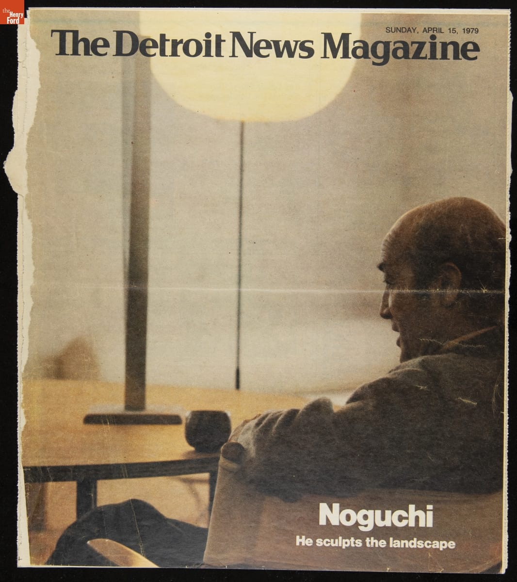 The Detroit News Magazine, "Noguchi: He Sculpts the Landscape," April 15, 1979 / front cover Page with text and image from behind/side of man sitting in a chair at a table with a globe-shaped lamp behind it