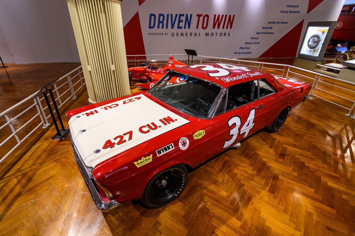 Wendell Scott, NASCAR’s first full-time Black driver, used this 1966 Ford Galaxie during the 1967–68 seasons. Red car with white hood; text in multiple areas including "34" on door and roof, "Wendell Scott" on roof