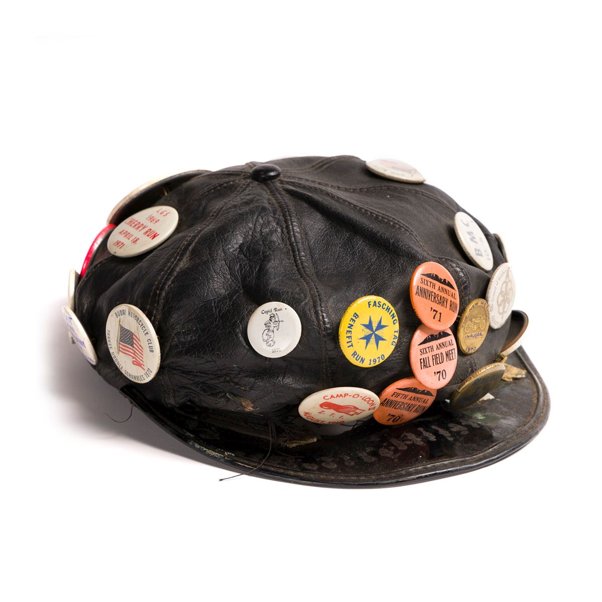 Leather cap with pins Black leather cap covered in buttons with images and text