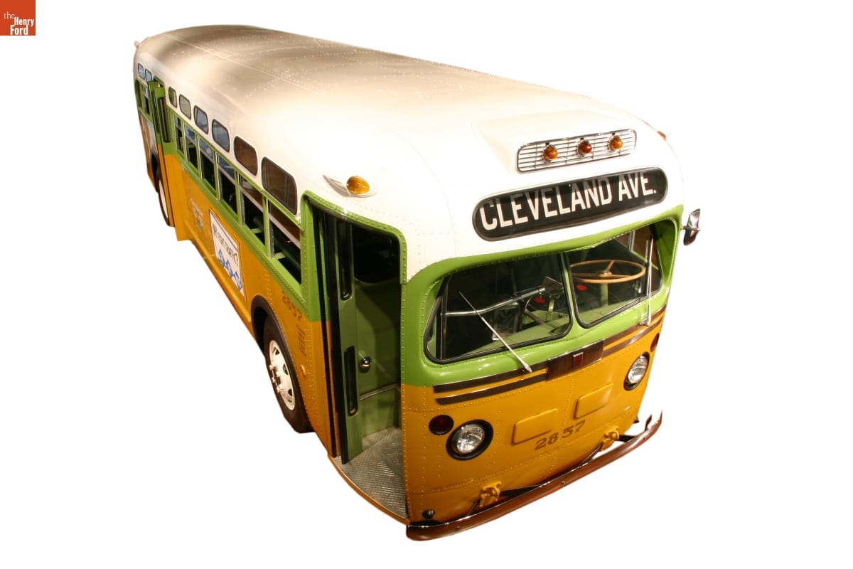 Rosa Parks Bus Lime green, mustard yellow, and white bus with sign "Cleveland Ave" on front