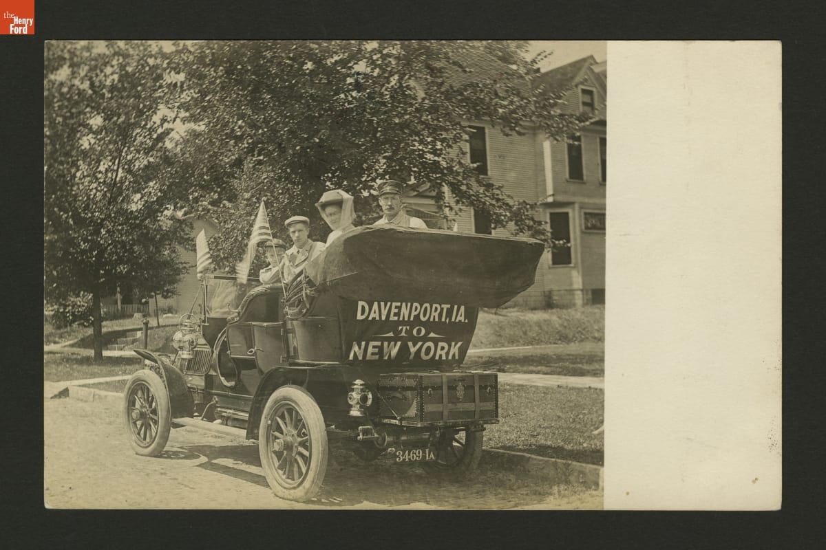People in a Car Traveling from Davenport, Iowa to New York, circa 1905 People sitting in an old-fashioned open car, with "Davenport, IA. to New York" written behind the rumble seat