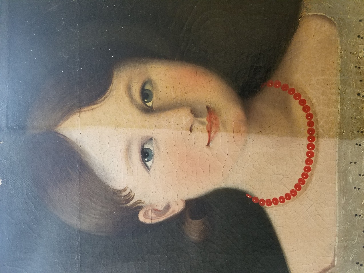 Detail shot showing varnish removed from half of the painting Painting of girl's face with paint on left side lighter and less yellowed than on right side