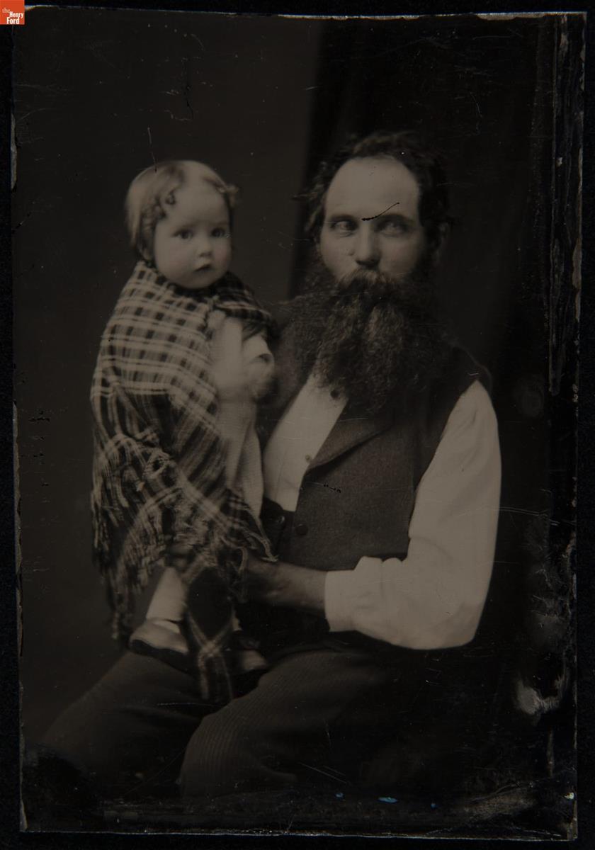 Silas McConnell Holding his Daughter Louise, circa 1876 Man holding child wrapped in plaid shawl or blanket