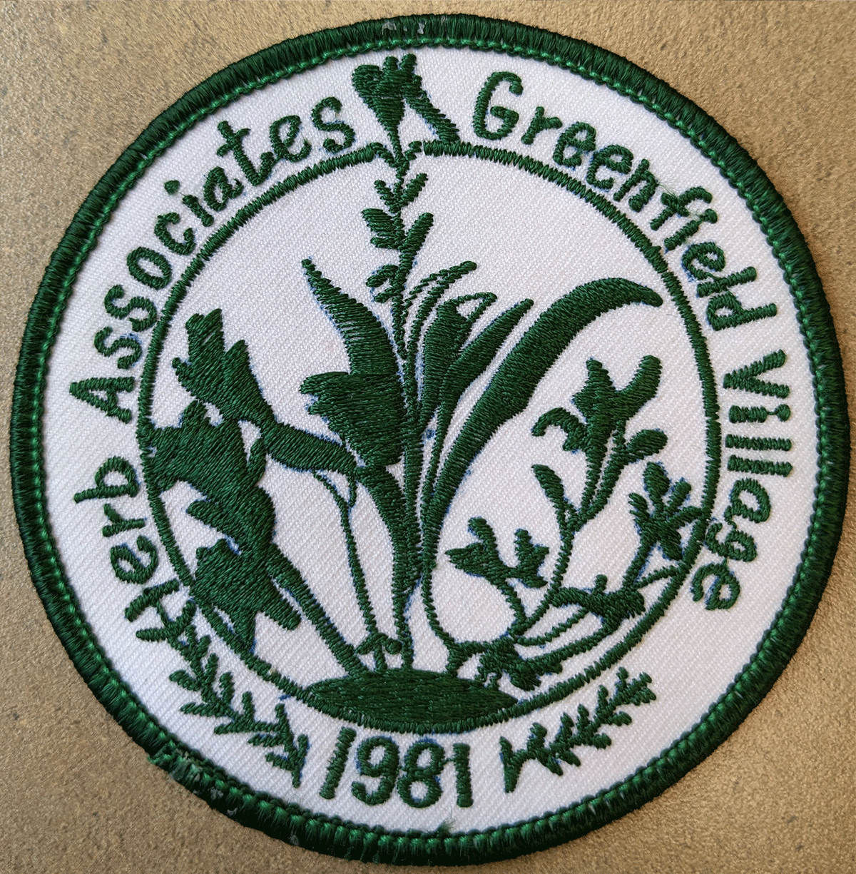 A green and white patch featuring illustrations of leaves