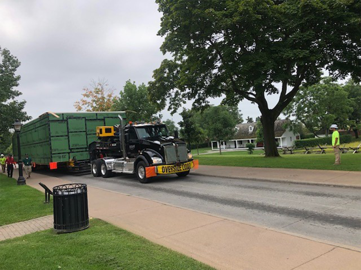 One half of The Jackson Home in its shipping container arriving at Greenfield Village and its two halves reunited on its new foundation. / Photos by Staff of The Henry Ford.