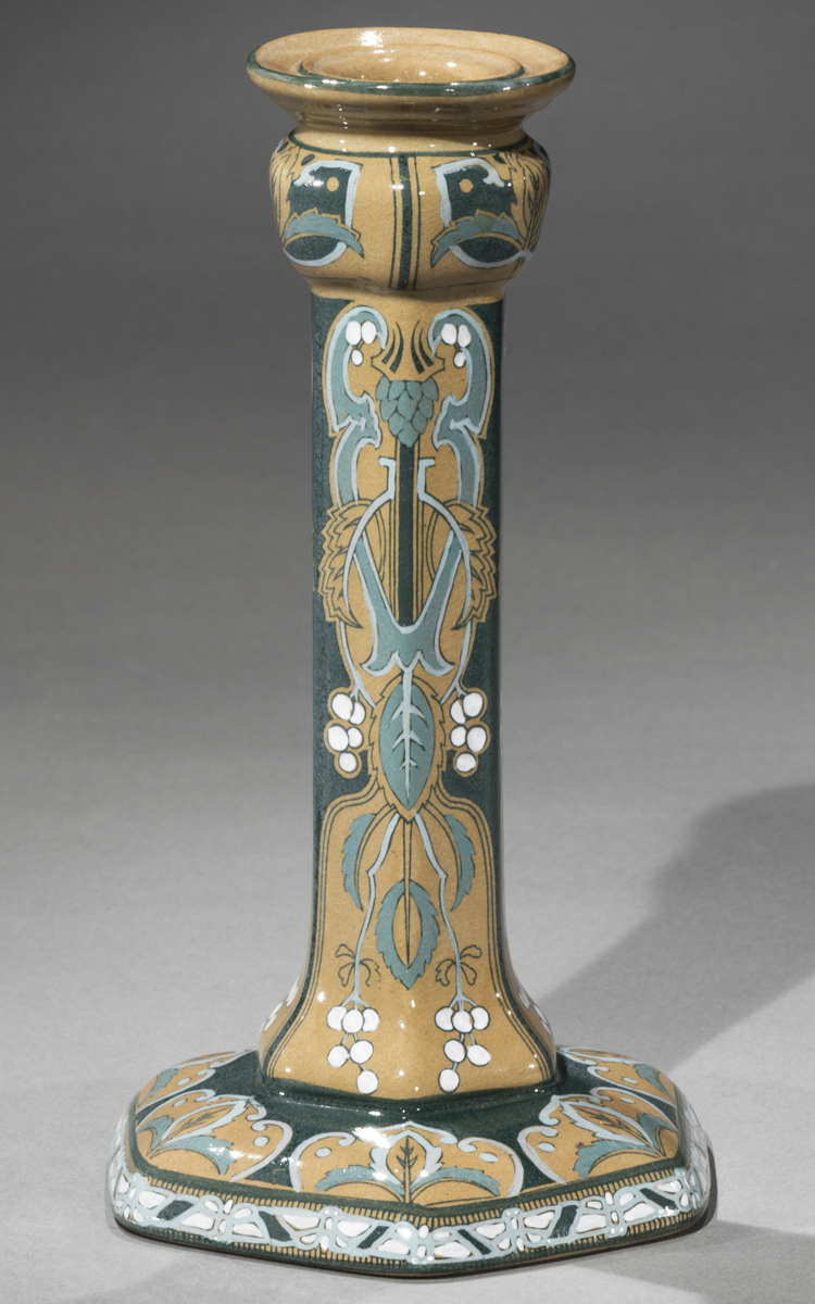 Buffalo Pottery was also known for its art pottery, decorated by artists and craftspeople to showcase artistic aspirations on utilitarian pieces like this candlestick decorated by Mabel Gerhardt in 1911.